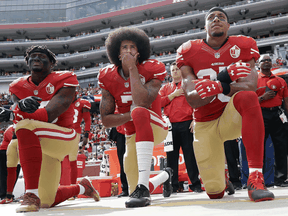 San Francisco 49ers quarterback Colin Kaepernick, centre, and other teammates kneel during the national anthem before an NFL football game on Oct. 2, 2016.