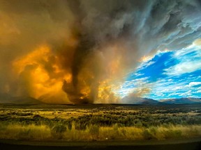 A funnel appears in a thick plume of smoke from the Loyalton Fire is seen in Lassen County, California, U.S. August 15, 2020.