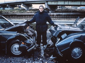 David Cronenberg on the set of Crash, with Toronto's Gardiner Expressway in the background.