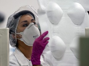 An employee works in the production of N95 face masks at a factory that produces 40,000 N95 masks per day, in Mexico City on May 21, 2020.