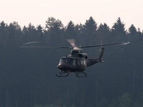 A UH model or "Huey" helicopter in flight.