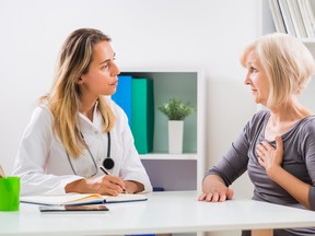 Patient telling doctor about pain in her chest