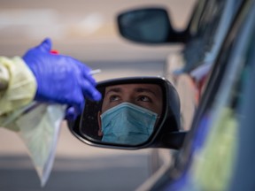 A man prepares to be tested at a coronavirus disease (COVID-19) drive-in testing location in Houston, Texas, U.S., August 18, 2020.