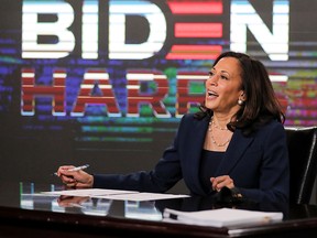 Democratic U.S. vice-presidential candidate Sen. Kamala Harris signs documents needed to receive her party's official nomination next week during an event in Wilmington, Del., on Aug. 14, 2020.