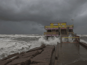 Waves from Hurricane Laura crash on a fishing pier on August 25, 2020 in Galveston, Texas.
