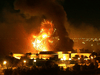 The presidential palace compound burns during a massive U.S.-led air raid in Baghdad on March 21, 2003.