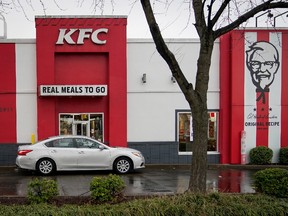 A vehicle waits at the drive-thru window of a Kentucky Fried Chicken (KFC) after a state mandated carry-out only policy went into effect in order to slow the spread of the novel coronavirus (COVID-19) in Louisville, Ky, U.S. March 24, 2020.