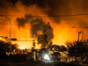 Smoke and fire rises over train cars after a train carrying crude oil derailed and exploded in the town of Lac-Megantic, Quebec, on July 6, 2013.