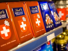 Tins of Lindt chocolate products sit on display inside the Lindt and Spruengli AG store at the company's factory in Kilchberg, Switzerland.