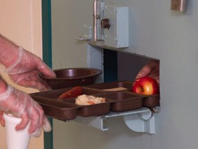 An inmate is given lunch at the segregation unit at Collins Bay Institution in Kingston, Ont., in 2016.