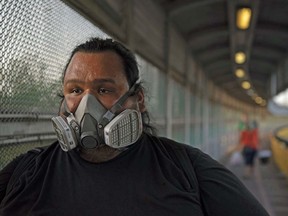 A pedestrian wearing a mask walks on the Gateway International Bridge toward Mexico in Brownsville, Texas, U.S., on Wednesday, July 29, 2020.