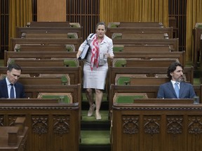 Sources say Prime Minister Justin Trudeau, right, will appoint Deputy Prime Minister Chrystia Freeland the new Minister of Finance after the departure Monday night of Bill Morneau, left.