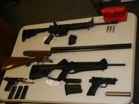 Police display a cache of illegal weapons that were seized from a home in Kelowna, B.C., in 2007.
