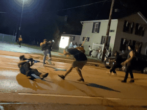 A person, identified later as 17-year-old Kyle Rittenhouse, fires a gun during a protest over the police shooting of Jacob Blake, a Black man, in Kenosha, Wisconsin, August 25, 2020.