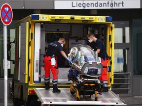 Medical personnel carry an emergency oxygen respiratory bed at the medical vehicle of the German Army or Bundeswehr, which carried the Russian opposition politician Alexei Navalny, in front of the Charite Hospital on August 22, 2020 in Berlin, Germany.