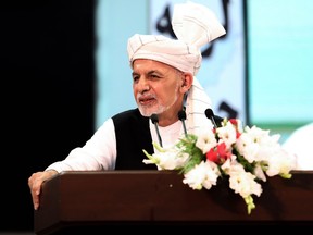 In this handout photograph taken on August 9, 2020 and released by the Press Office of President of Afghanistan, Afghan President Ashraf Ghani speaks during the last day of the Loya Jirga, a grand assembly, at the Loya Jirga Hall in Kabul.