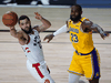 Toronto Raptors guard Fred VanVleet passes the ball against Los Angeles Lakers forward LeBron James.