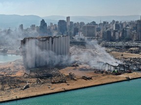 An aerial view shows the massive damage done to Beirut port's grain silos (C) and the area around it on August 5, 2020, one day after a mega-blast tore through the harbour in the heart of the Lebanese capital with the force of an earthquake, killing more than 100 people and injuring over 4,000