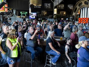 People watch a concert at the Full Throttle Saloon during the 80th Annual Sturgis Motorcycle Rally in Sturgis, South Dakota on August 9, 2020. While the rally usually attracts around 500,000 people, officials estimate that more than 250,000 people may still show up to this year's festival despite the coronavirus pandemic.