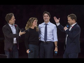Co-founders Craig, left, and Marc Kielburger introduce Prime Minister Justin Trudeau, second from right, and his wife Sophie Gregoire-Trudeau, during WE Day celebrations in Ottawa, in 2015.