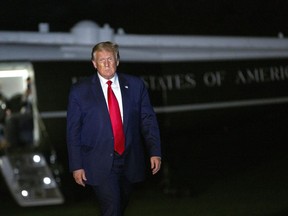 U.S. President Donald Trump walks on the South Lawn of the White House after arriving on Marine One in Washington, D.C., U.S., on Sunday, Aug. 9, 2020. A new opinion survey suggests Donald Trump's recent decision to slap a tariff on Canadian aluminum is garnering poor reviews on both sides of the border.