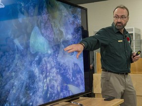 Parks Canada archaeologist Marc-Andre Bernier shows reporters an image captured during the discovery of the HMS Erebus's ship's bell in Ottawa on Thursday, Nov. 6, 2014. or only the second time in 12 years, Bernier and his underwater archeology team at Parks Canada will not be heading north this month to explore the wrecks of the doomed Arctic expedition of Sir John Franklin and his crew.