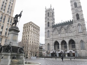 One of Canada's best-known religious landmarks, the Notre-Dame Basilica in Montreal, is asking for urgent financial assistance from all levels of government to withstand a budget shortfall caused by COVID-19. A woman walks by Notre-Dame Basilica in Montreal, Friday, April 10, 2020, as COVID-19 cases rise in Canada and around the world.
