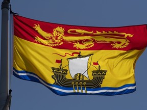 New Brunswick's provincial flag flies on a flag pole in Ottawa, Monday, July 6, 2020. More than one week into New Brunswick's campaign, the main issue has become the post-COVID economic recovery.