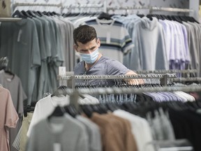 A man wears a face mask as he shops at a department store in Montreal, Sunday, August 2, 2020, as the COVID-19 pandemic continues in Canada and around the world.