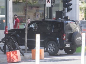 A jeep mounts the sidewalk after speeding down a pedestrian zone on Sainte-Catherine Street in Montreal, Saturday, Aug. 8, 2020.THE CANADIAN PRESS/Graham Hughes