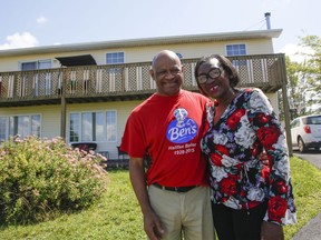 Christopher Downey and his wife Chrissy pose in front of their home in North Preston, N.S., Saturday, August 1, 2020. Christopher Downey finished building his home in 2002 on a parcel of land in North Preston, N.S., that has been in his family for generations. But it was only in late July that Downey says he found out the province intends to issue him a certificate of claim to the land upon which his house was built, the first step in his years-long fight for title.