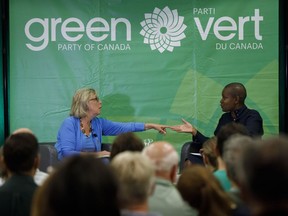 Green Party of Canada leader Elizabeth May, left, speaks with Toronto area candidate Annamie Paul during a fireside chat about the climate, in Toronto on September 3, 2019. Green party leadership hopeful Annamie Paul is solidifying her spot as a front-runner in the race to succeed Elizabeth May at the party's helm. Party data show as of the end of July, Paul's financial haul is almost $121,000, more than one-third of the total raised by all nine candidates in the race.