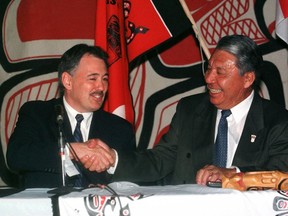 B.C. Premier Glen Clark and Nisga'a Tribal Council President Joe Gosnell shake hands after signing the Nisga'a Final Agreement in Terrace, B.C., on April 27, 1999. Joe Gosnell, a renowned treaty negotiator, politician and leader of the Nisga'a Nation, has died at the age of 85. A statement from the Nisga'a Lisims government of northwestern British Columbia says Gosnell died in his home in New Aiyansh after a long battle with cancer. A hereditary Nisga'a chieftain of the Eagle Clan, Gosnell was president of the nation when it signed the landmark Nisga'a Final Agreement in 2000.