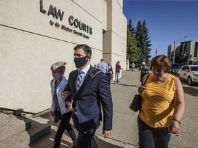 Matthew McKnight holds arms with his mother as they walk into court, in Edmonton on Friday July 10, 2020. Crown prosecutors have filed a notice of appeal over the sentence given to a former Edmonton nightclub employee convicted of sexually assaulting five women. Matthew McKnight, 33, was sentenced to eight years in prison on July 31. If the appeal is granted, prosecutors say they will challenge the sentence on several grounds including that it's "demonstrably unfit."