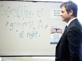 B.C. Minister of Education Rob Fleming walks past a white board at Monterey Middle School following an update on part-time return to classes in Victoria, B.C., on June 2, 2020.