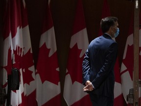 Minister of Finance Bill Morneau leaves after walking into the room before staff were ready, ahead of a news conference where he is expected to announce his resignation, on Parliament Hill in Ottawa, on Monday, Aug. 17, 2020.