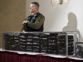 O.P.P officers guard 55 kilograms of cocaine during a press conference in Barrie, Ont., on Wednesday, April 3, 2019. Federal prosecutors are being instructed to criminally prosecute only the most serious drug possession offences and to find alternatives outside the criminal justice system for the rest.