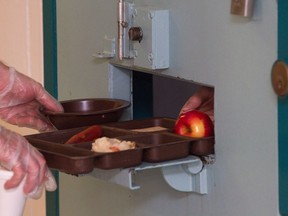 An inmate is given lunch at the segregation unit at Collins Bay Institution in Kingston, Ont., on Tuesday, May 10, 2016. An independent panel tasked with overseeing segregation of inmates in federal prisons says Correctional Service Canada blocked the panel from doing its job. THE CANADIAN/Lars Hagberg