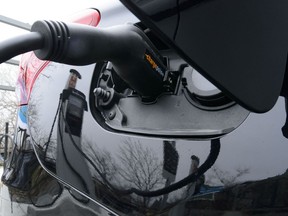 A car is charged at a charge station for electric vehicles on Parliament Hill in Ottawa on Wednesday, May 1, 2019. Electric-car advocates are pushing Ottawa to put more money into its zero-emission vehicle rebate program and expand it to include used cars in the next federal budget.