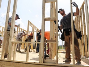 Workers build the frame of a Habitat for Humanity house as their United Way's Day of Caring project on Tuesday, Sept. 10, 2019, in Decatur, Ala. The head of a group that promotes charities says there are concerns about long-term negatives impacts in the sector from the ongoing WE controversy on Parliament Hill. THE CANADIAN PRESS/AP-Jeronimo Nisa/The Decatur Daily via AP)