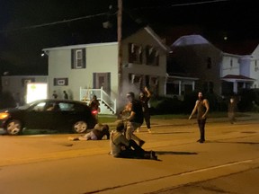 A man is being shot in his arm during a protest following the police shooting of Jacob Blake, a Black man, in Kenosha, Wisconsin, U.S., August 25, 2020, in this still image obtained from a social media video.
