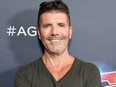 Simon Cowell broke his back while testing an electric bicycle at his home in Malibu.
