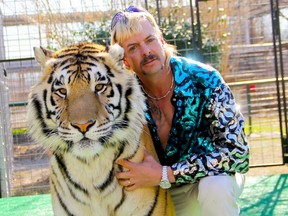 In this file undated photo courtesy of Netflix shows Joseph "Joe Exotic" Maldonado-Passage with one of his tigers obtained on january 20, 2020.