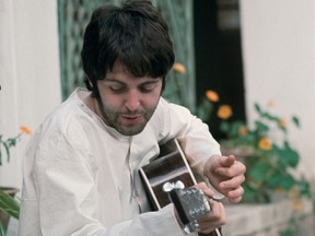 In a detail from one of Saltzman's photos, Paul McCartney looks down at the lyrics to Ob-La-Di, Ob-La-Da, which he hadn't yet memorized.