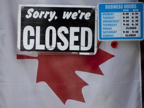 A 'Closed' sign hangs in a store window in Ottawa, Thursday April 16, 2020.