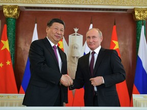 Russian President Vladimir Putin, right, and Chinese President Xi Jinping shake hands after their talks at the Kremlin in Moscow in 2019.