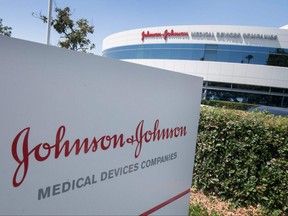 The Johnson & Johnson logo is seen above an entrance to a building at their campus in Irvine, California on August 28, 2019. The US government on August 5, 2020 announced a new $1 billion investment in a COVID-19 vaccine being developed by Johnson & Johnson, guaranteeing 100 million doses.