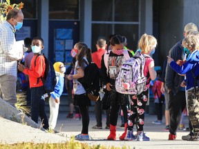 Students at Mayland Heights School in Calgary gather before the bell on Sept. 1.