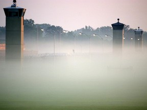 In this file photo guard towers surrounding the Federal Prison in Terre Haute, Indiana rise out of the early morning fog on June 9, 2001.