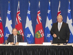 Ontario Premier Doug Ford stands alongside Quebec Premier Francois Legault, as he speaks to the media, at the start of the Ontario-Quebec Summit, in Toronto, on Wednesday, September 9, 2020.